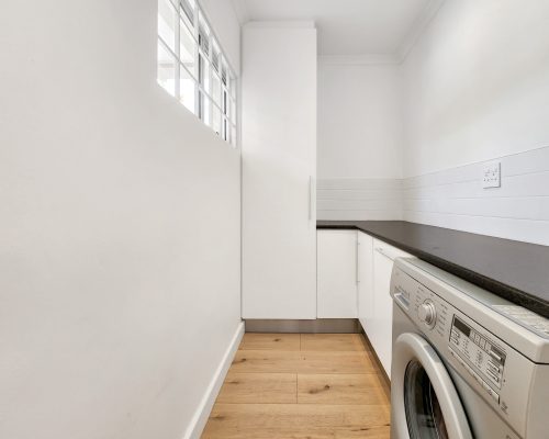 Luxury Beach Holiday Accommodation in Sunset Beach, Cape Town Separate laundry washroom with washing machine at sunset beach house luxury holiday accommodation Cape Town