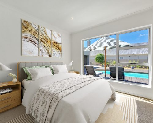 Luxury Beach Holiday Accommodation in Sunset Beach, Cape Town Spacious bedroom with direct pool and deck view at sunset beach house luxury holiday accommodation Cape Town